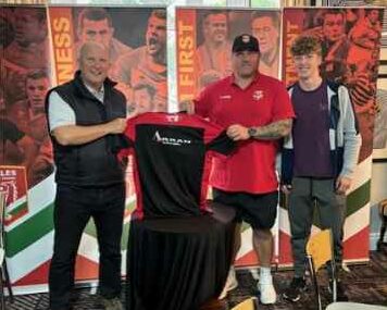 sponsorship image of nigel and others holding top